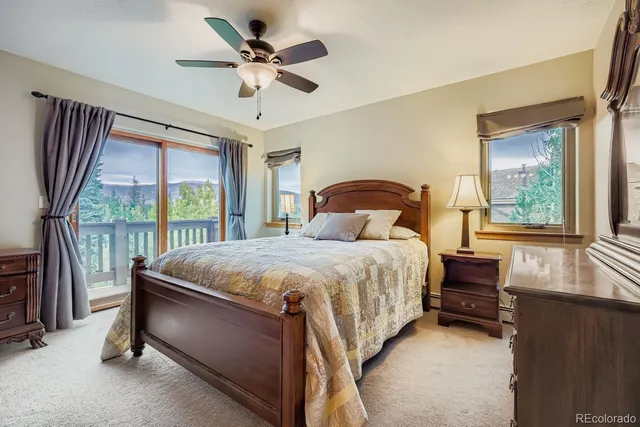 a bedroom with a large bed and a balcony tv