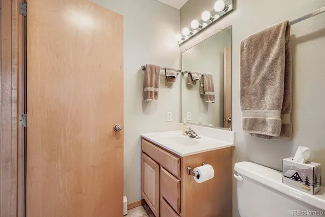 a bathroom with a sink a toilet a mirror and shower