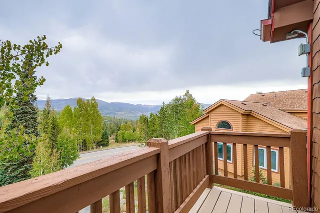 a view of a wooden deck and a yard