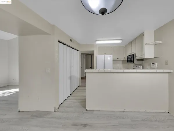 a kitchen with stainless steel appliances granite countertop a refrigerator a sink a stove a microwave and island