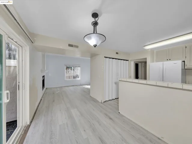 a view of a kitchen with wooden floor