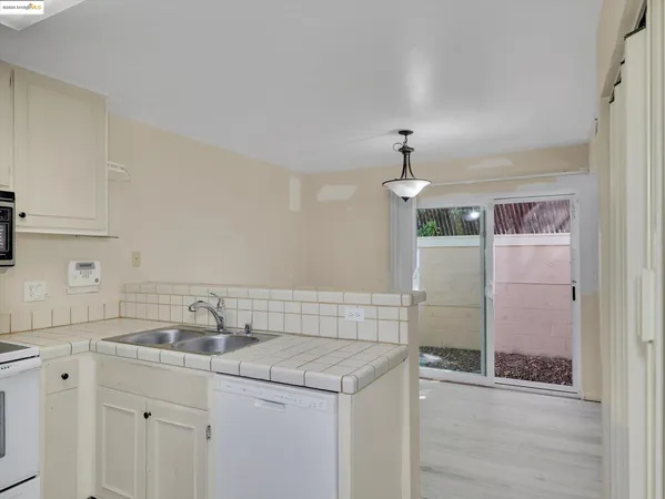 a kitchen with a refrigerator stove and sink