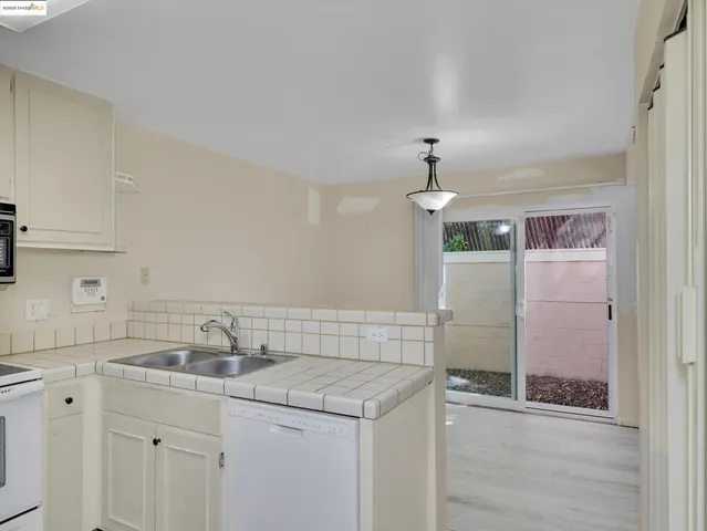 a kitchen with a refrigerator stove and sink