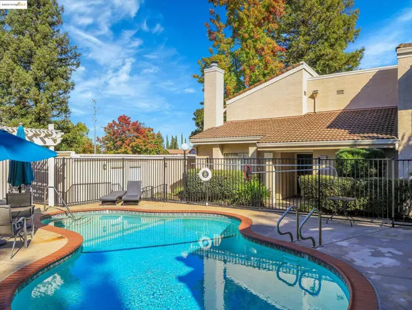 a view of a house with backyard water and a patio