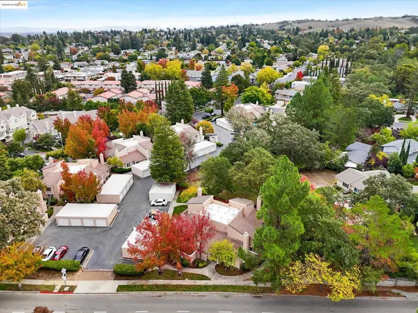 an aerial view of a house with a yard and garden