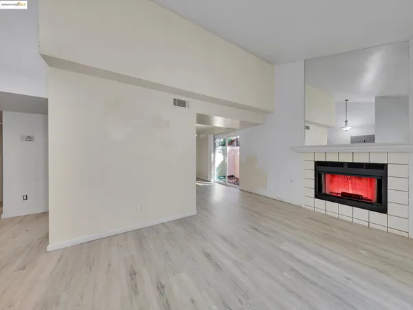 a view of an empty room and wooden floor