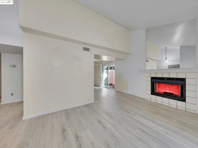 a view of an empty room and wooden floor