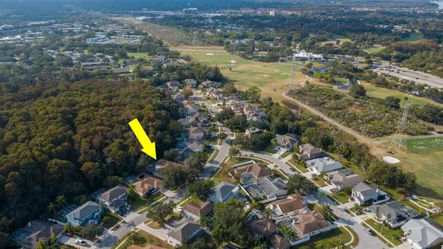 an aerial view of house with yard and mountain view in back
