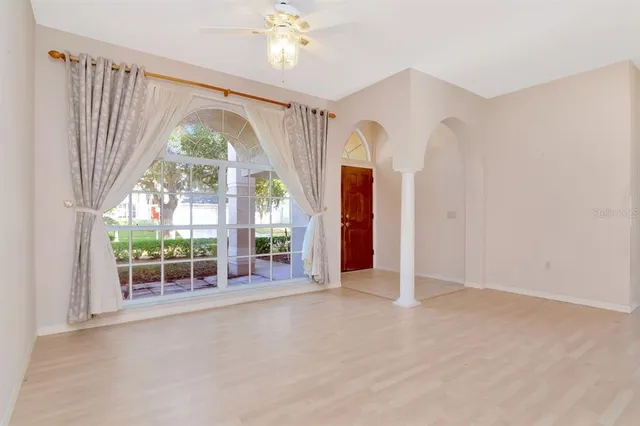 a view of a room with wooden floor and white walls