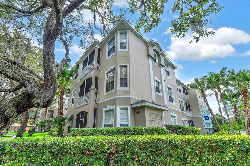 1224 South Hiawassee Road, Unit 635 Orlando, FL 32835 - Photo 1 of 1 a view of a big white building among the large trees