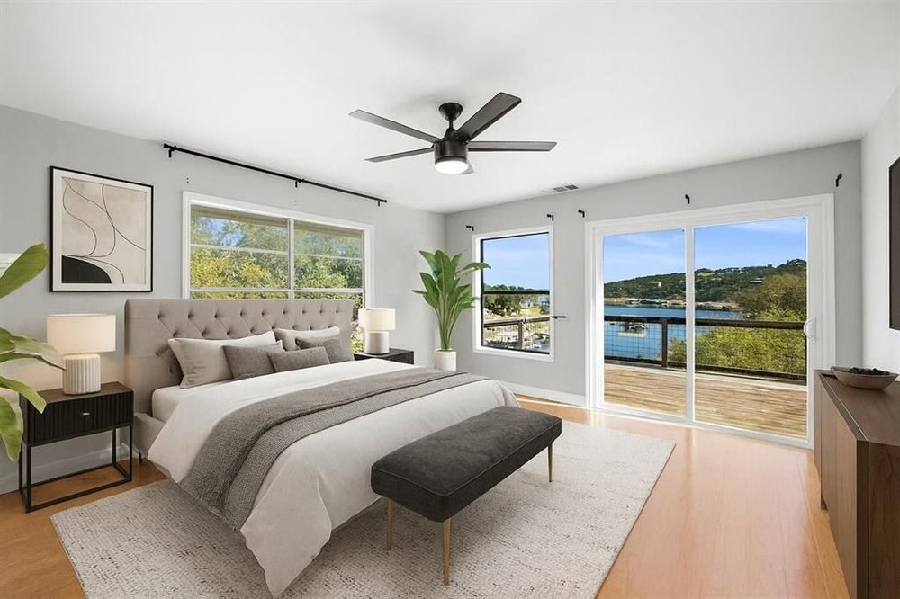 20204 Barnett Glenn Road Spicewood, TX 78669 - Photo 16 of 34 a bedroom with a large bed and a large window