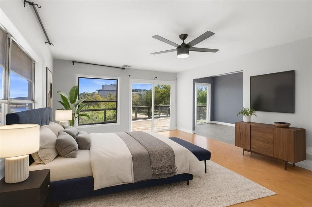 20204 Barnett Glenn Road Spicewood, TX 78669 - Photo 17 of 34 a bedroom with a bed and a flat screen tv