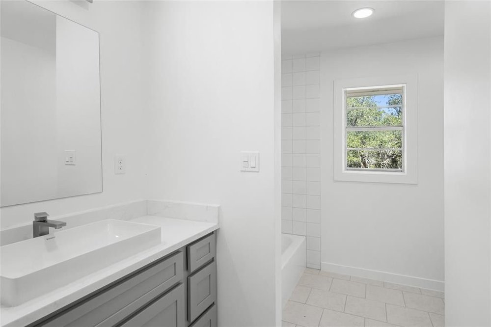 20204 Barnett Glenn Road Spicewood, TX 78669 - Photo 22 of 34 a bathroom with a sink and a mirror