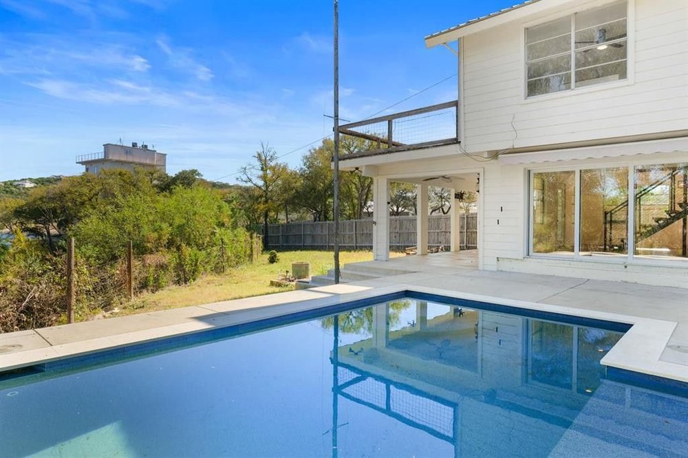 20204 Barnett Glenn Road Spicewood, TX 78669 - Photo 26 of 34 a view of a house with a swimming pool