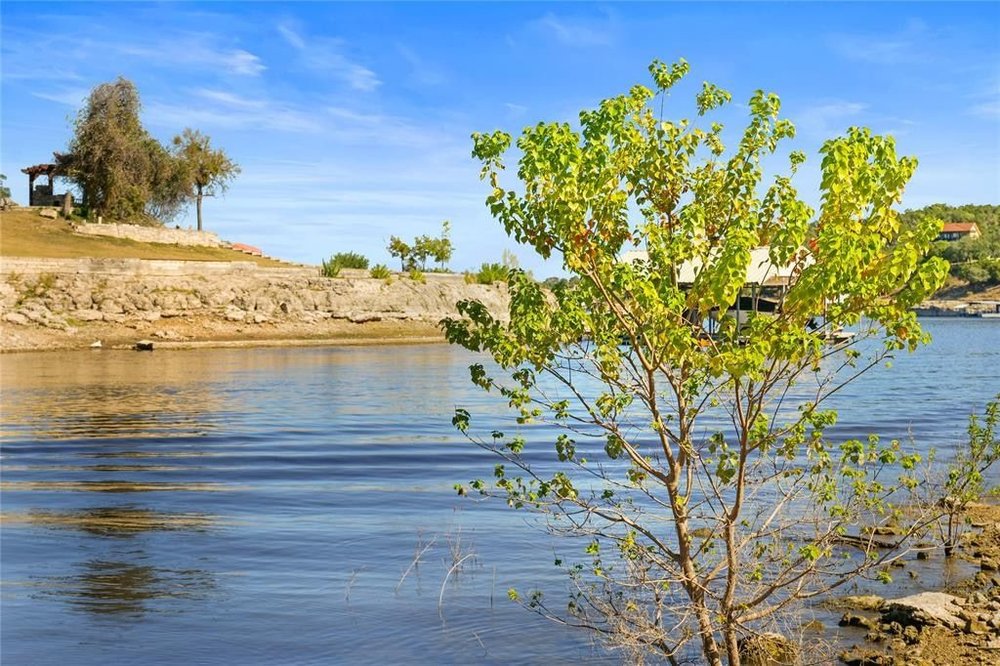 20204 Barnett Glenn Road Spicewood, TX 78669 - Photo 31 of 34 a view of a lake with an outdoor space