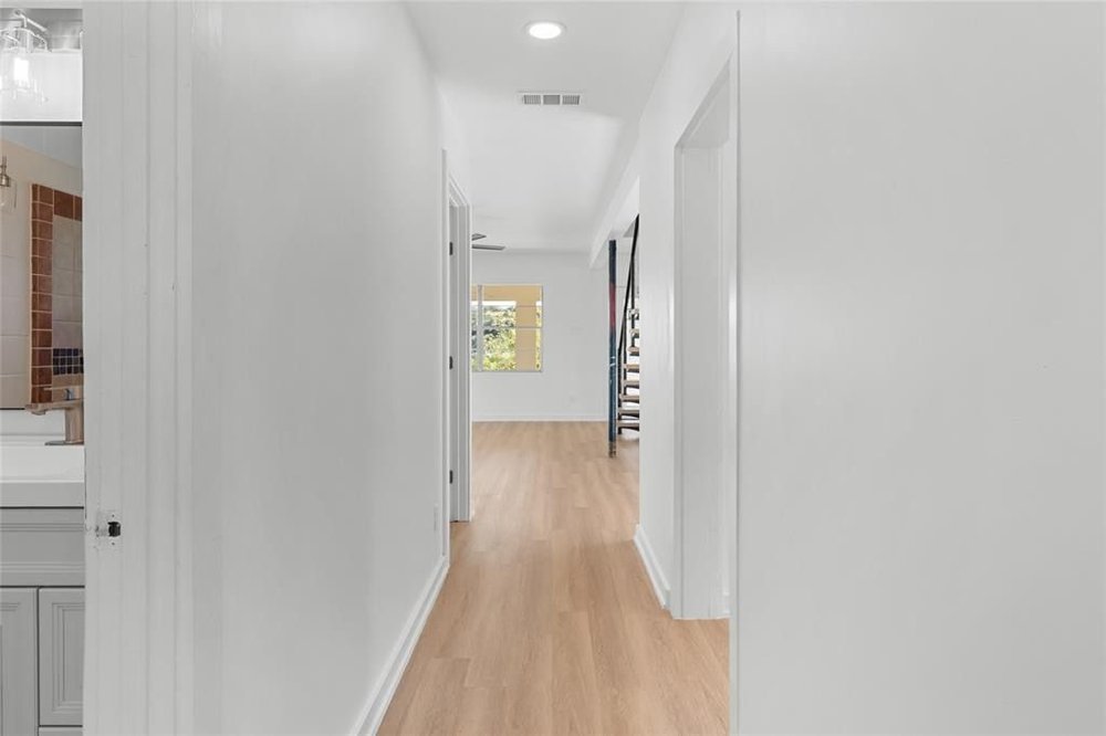 20204 Barnett Glenn Road Spicewood, TX 78669 - Photo 5 of 34 a view of a hallway with wooden floor