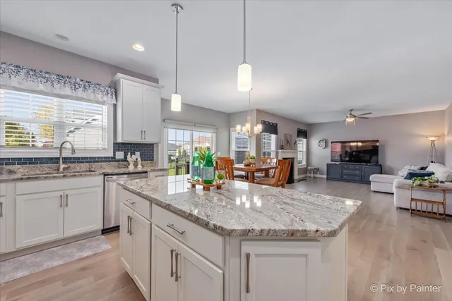 a kitchen with sink stove and cabinets