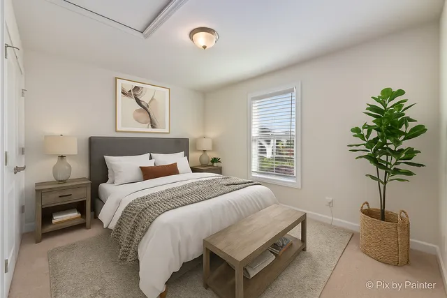 a bed room with a bed and a potted plant