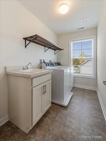 a kitchen with sink and cabinets