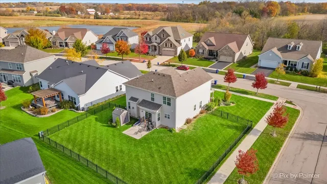 an aerial view of residential house with outdoor space and pool