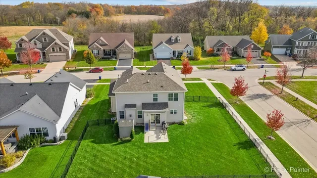 an aerial view of residential houses with outdoor space and parking