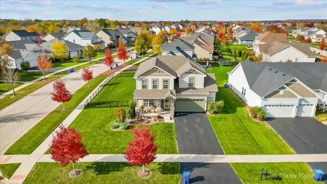 an aerial view of residential houses with outdoor space and street view