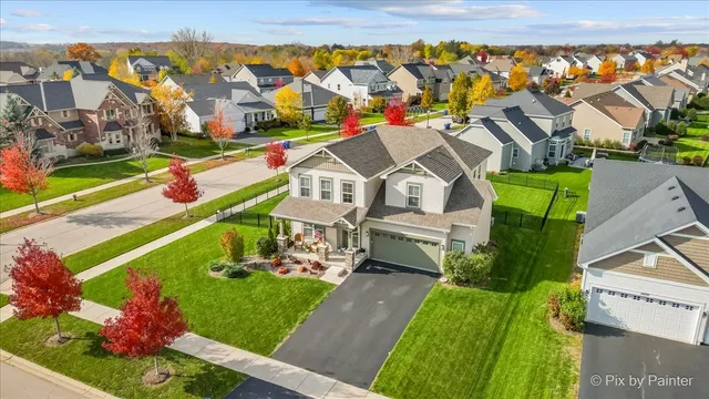 a front view of house with yard and green space