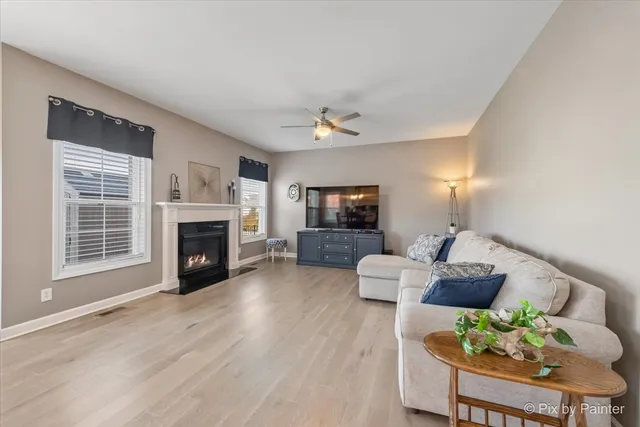 a living room with furniture a fireplace and a table