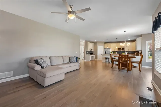 a living room with furniture and kitchen view