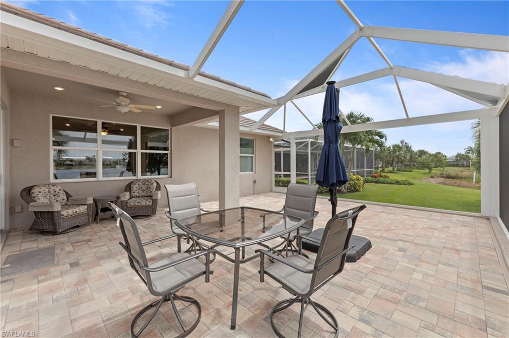 10507 Jackson Square Drive Estero, FL 33928 - Photo 31 of 46 a patio with yard table and chairs