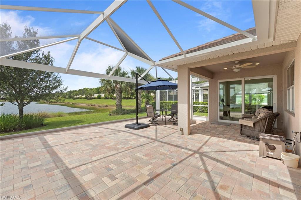 10507 Jackson Square Drive Estero, FL 33928 - Photo 33 of 46 a view of a patio with a table and chairs under an umbrella