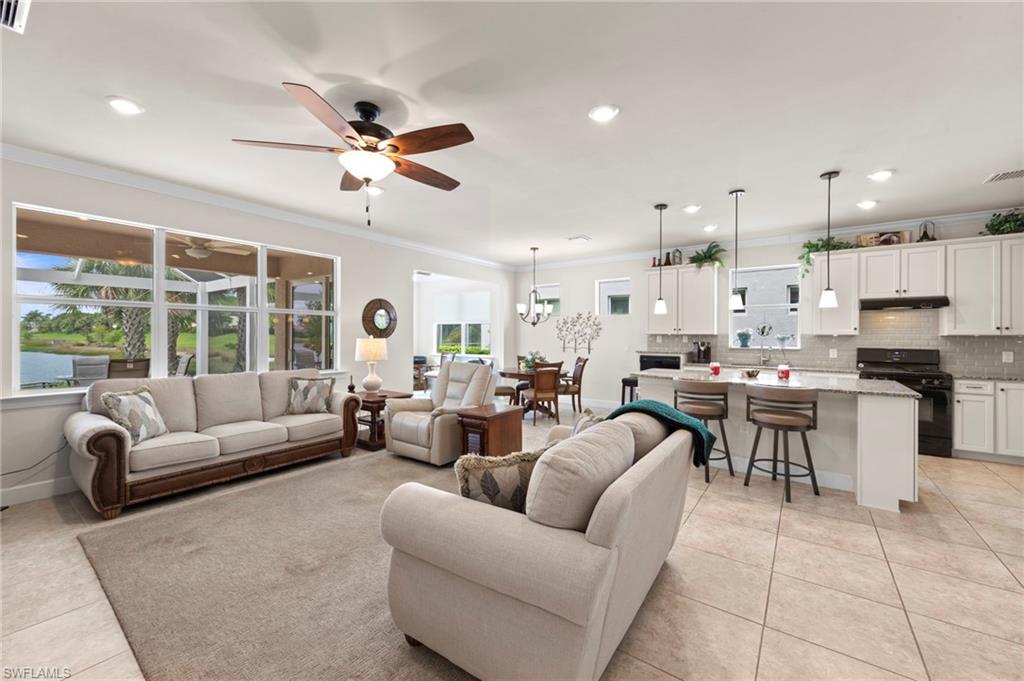 10507 Jackson Square Drive Estero, FL 33928 - Photo 8 of 46 a living room with furniture kitchen and a chandelier