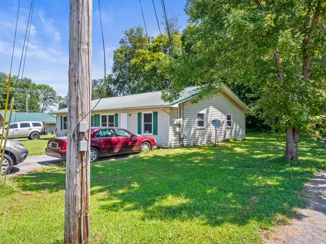 an aerial view of a house with a yard basket ball court and outdoor seating