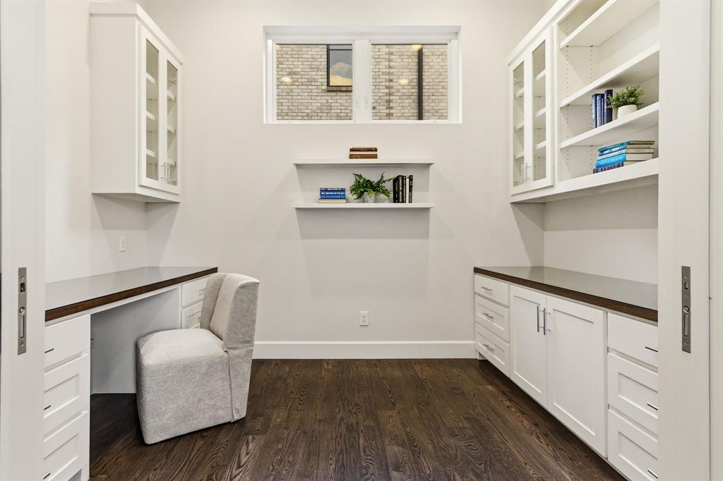 6523 Northwood Road Dallas, TX 75225 - Photo 16 of 36 a hallway with cabinets and wooden floor