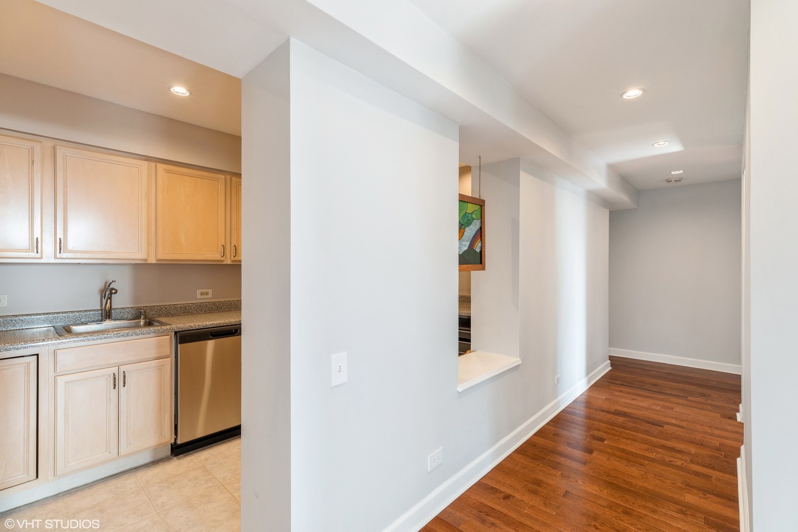 40 East 9th Street, Unit 1605 Chicago, IL 60605 - Photo 8 of 21 a kitchen with granite countertop white cabinets and white appliances