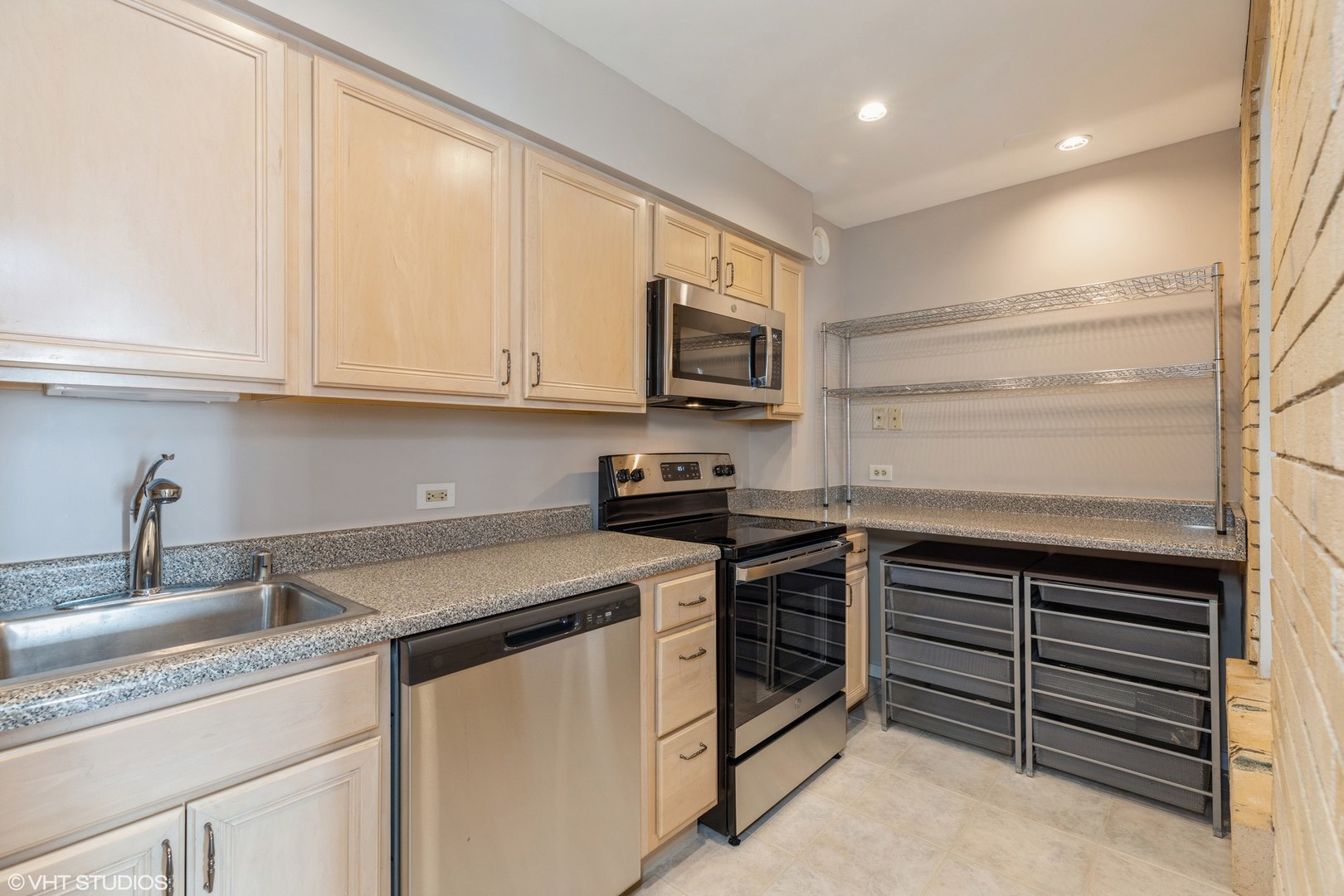 40 East 9th Street, Unit 1605 Chicago, IL 60605 - Photo 9 of 21 a kitchen with stainless steel appliances granite countertop a sink and a stove
