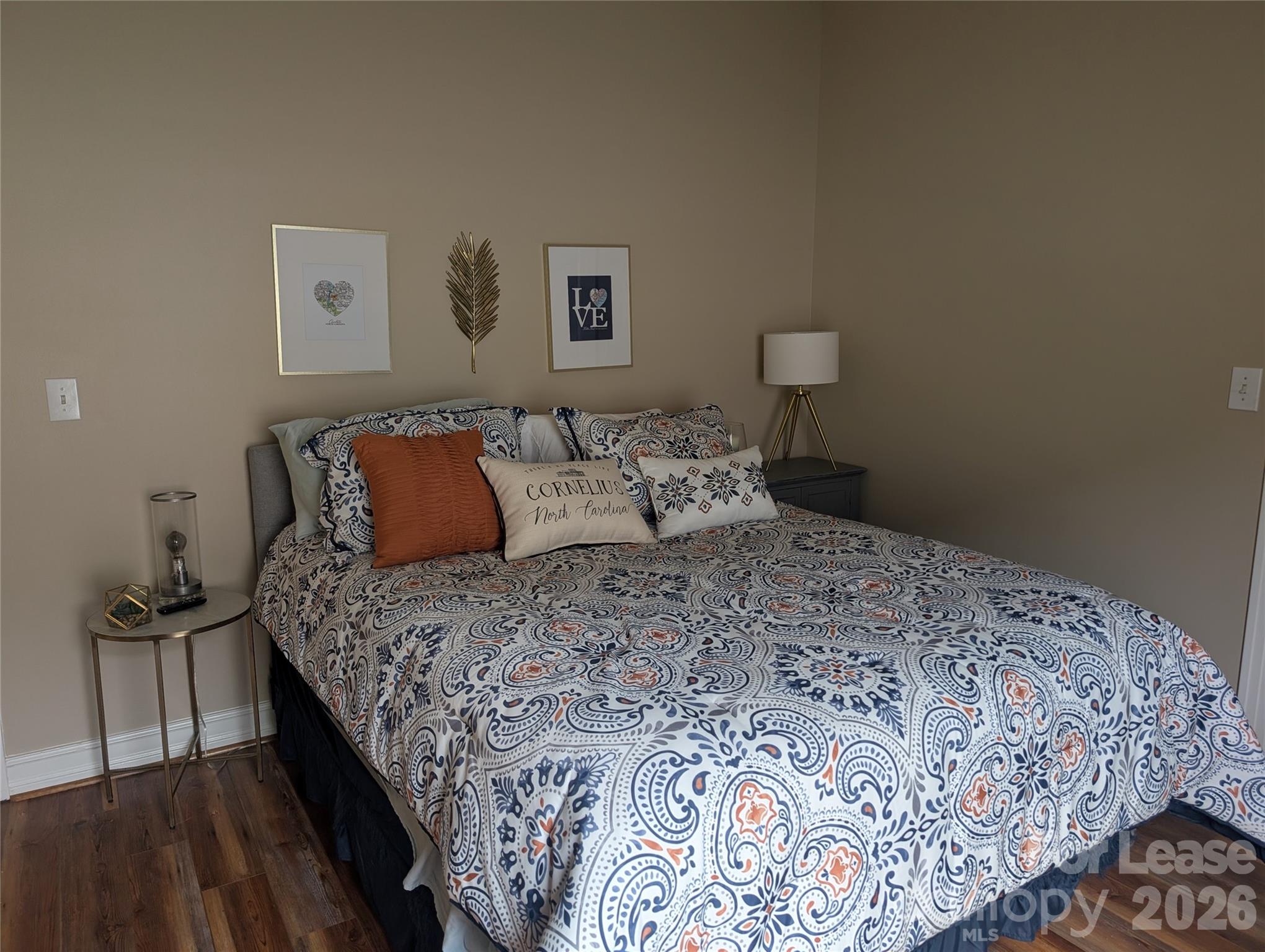 20207 Colony Point Lane Cornelius, NC 28031 - Photo 20 of 26 a bedroom with a bed and painting on the wall
