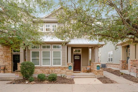 a front view of a house with a yard and glass windows