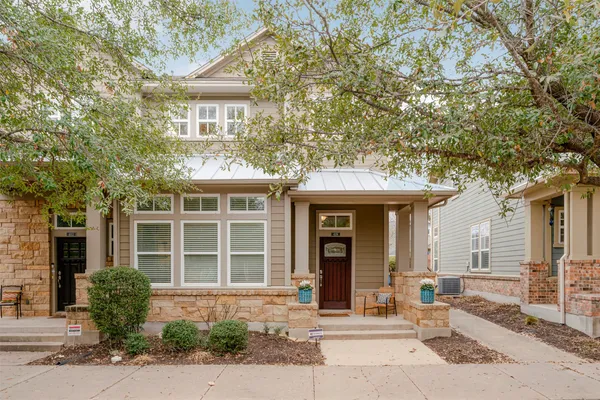 a front view of a house with a yard and glass windows