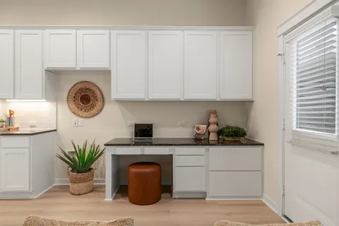 a kitchen with a cabinets a sink and a stove