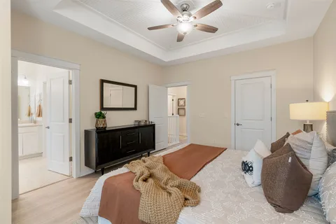 a bedroom with a bed and a chandelier