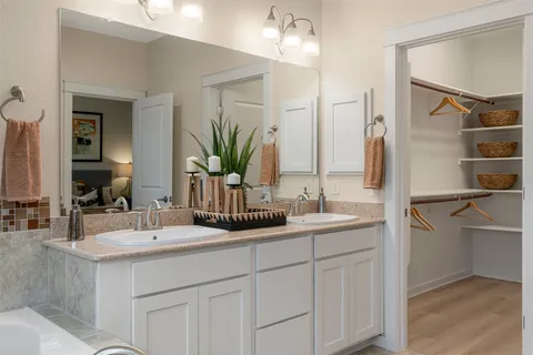 a bathroom with 2 sink and a mirror