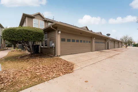 a front view of a house with basket ball court and glass windows