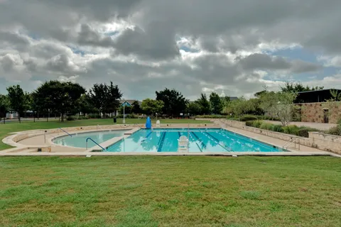 a view of a swimming pool with a yard