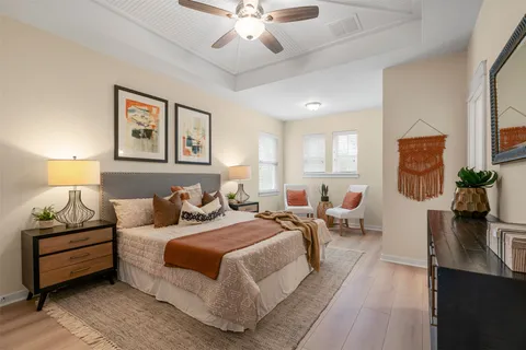 a bedroom with bed couch and window