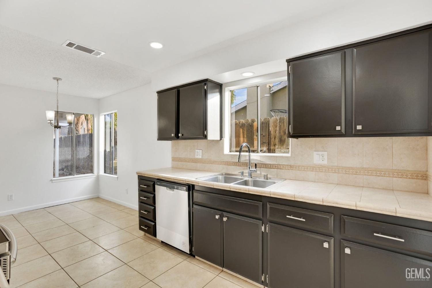 Undisclosed Address Bakersfield, CA 93304 - Photo 13 of 31 a kitchen with a sink and a refrigerator