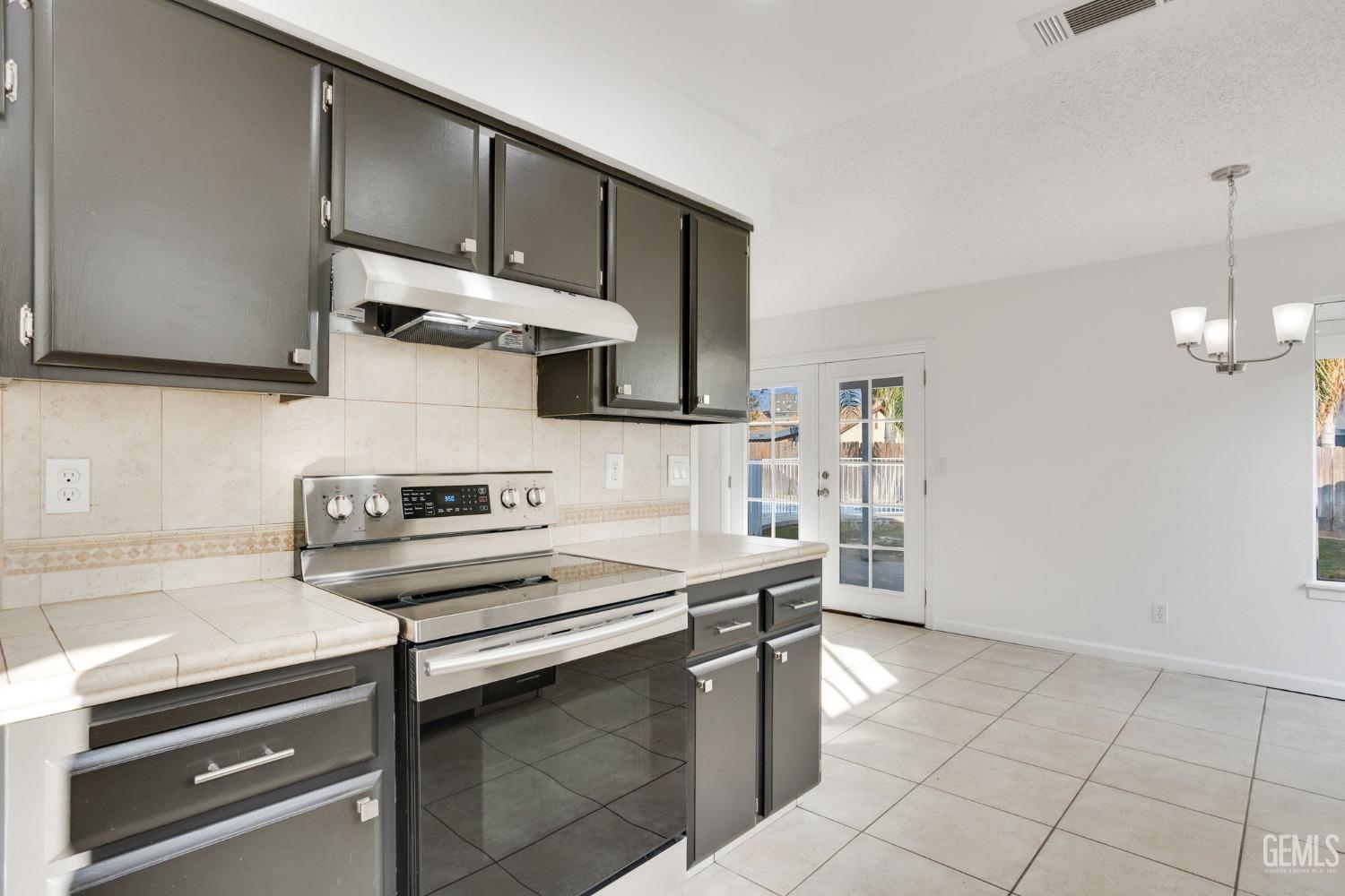 Undisclosed Address Bakersfield, CA 93304 - Photo 14 of 31 a kitchen with a sink appliances and cabinets