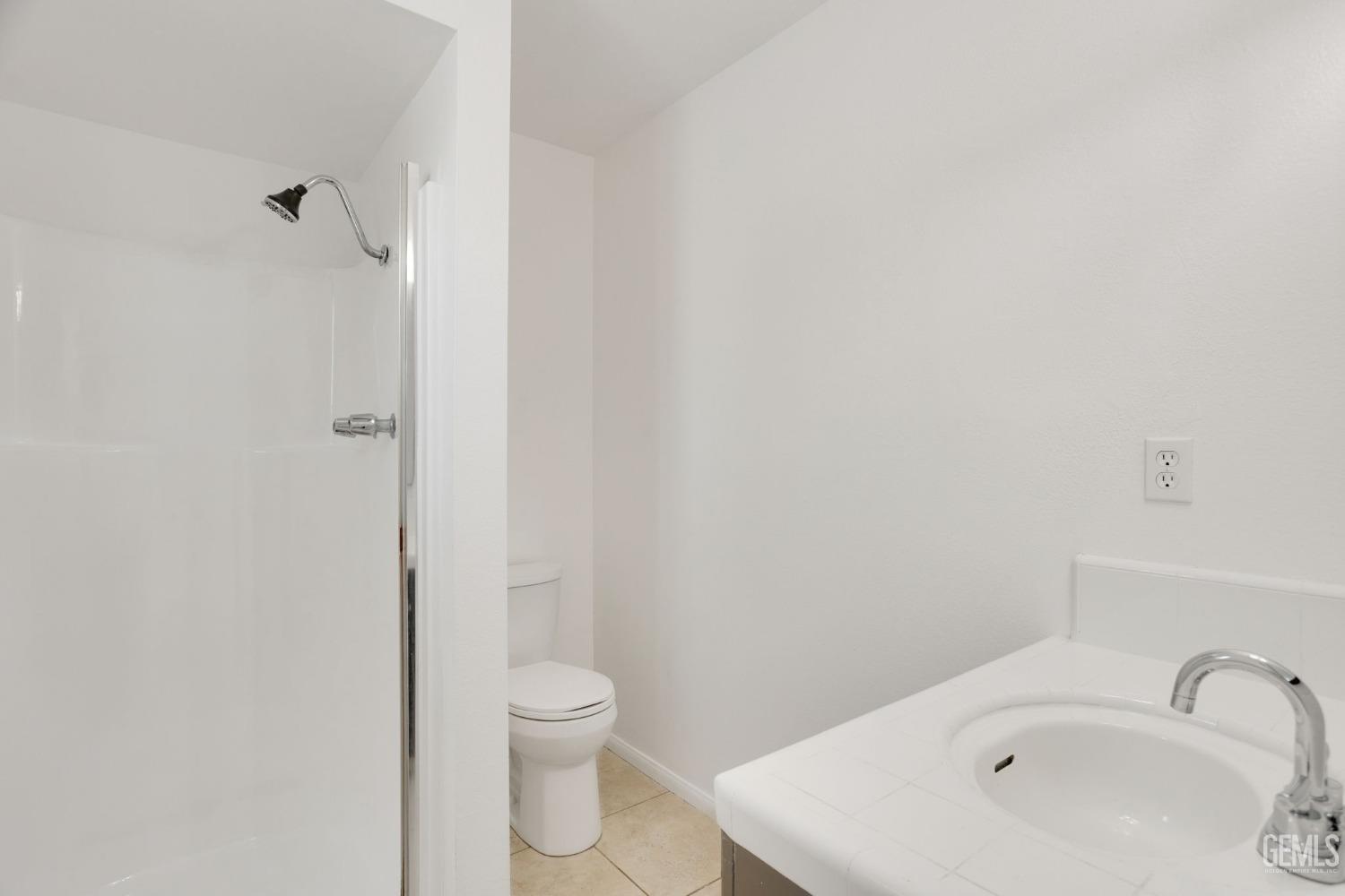 Undisclosed Address Bakersfield, CA 93304 - Photo 19 of 31 a bathroom with a sink a toilet and shower