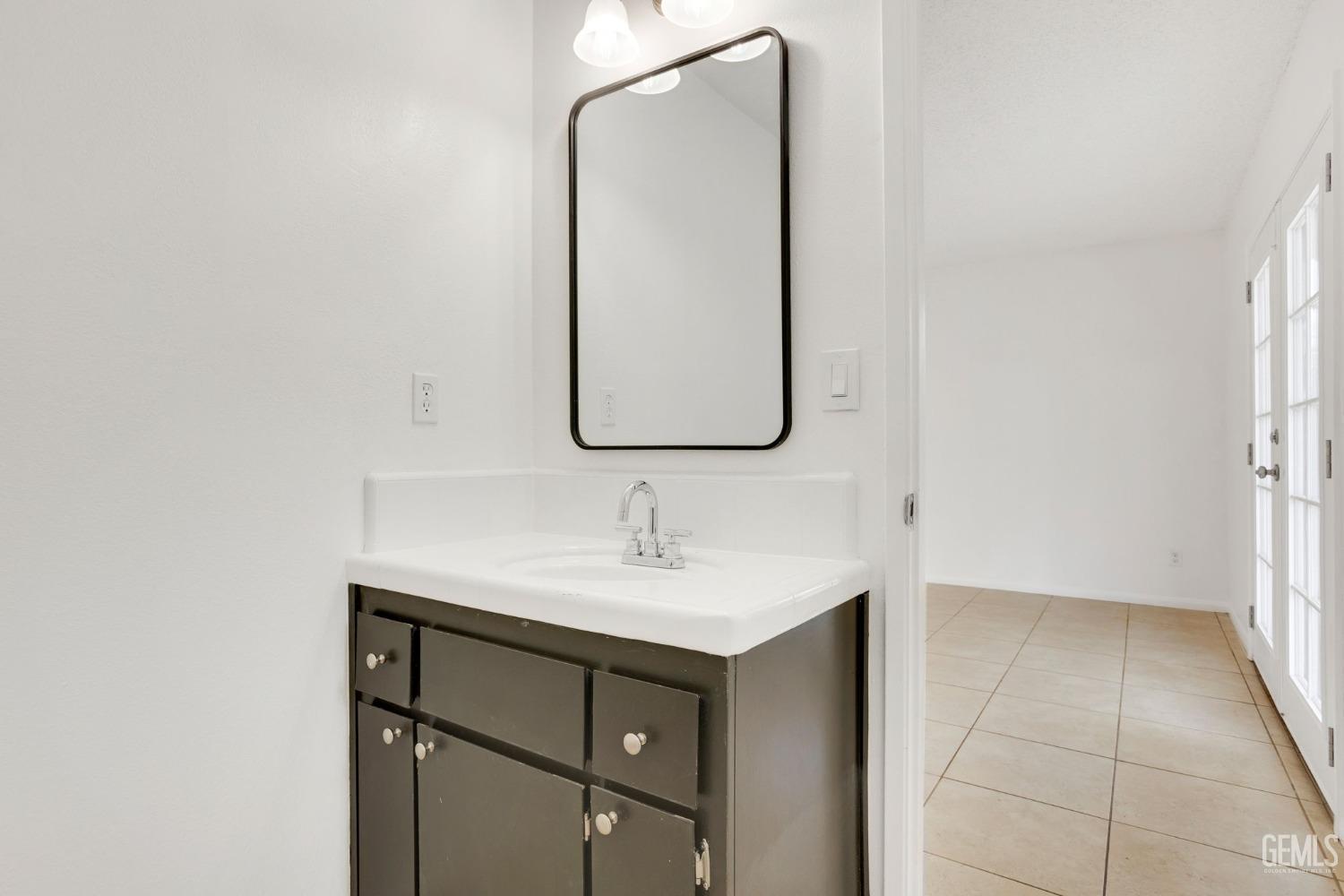 Undisclosed Address Bakersfield, CA 93304 - Photo 20 of 31 a bathroom with a sink and a mirror