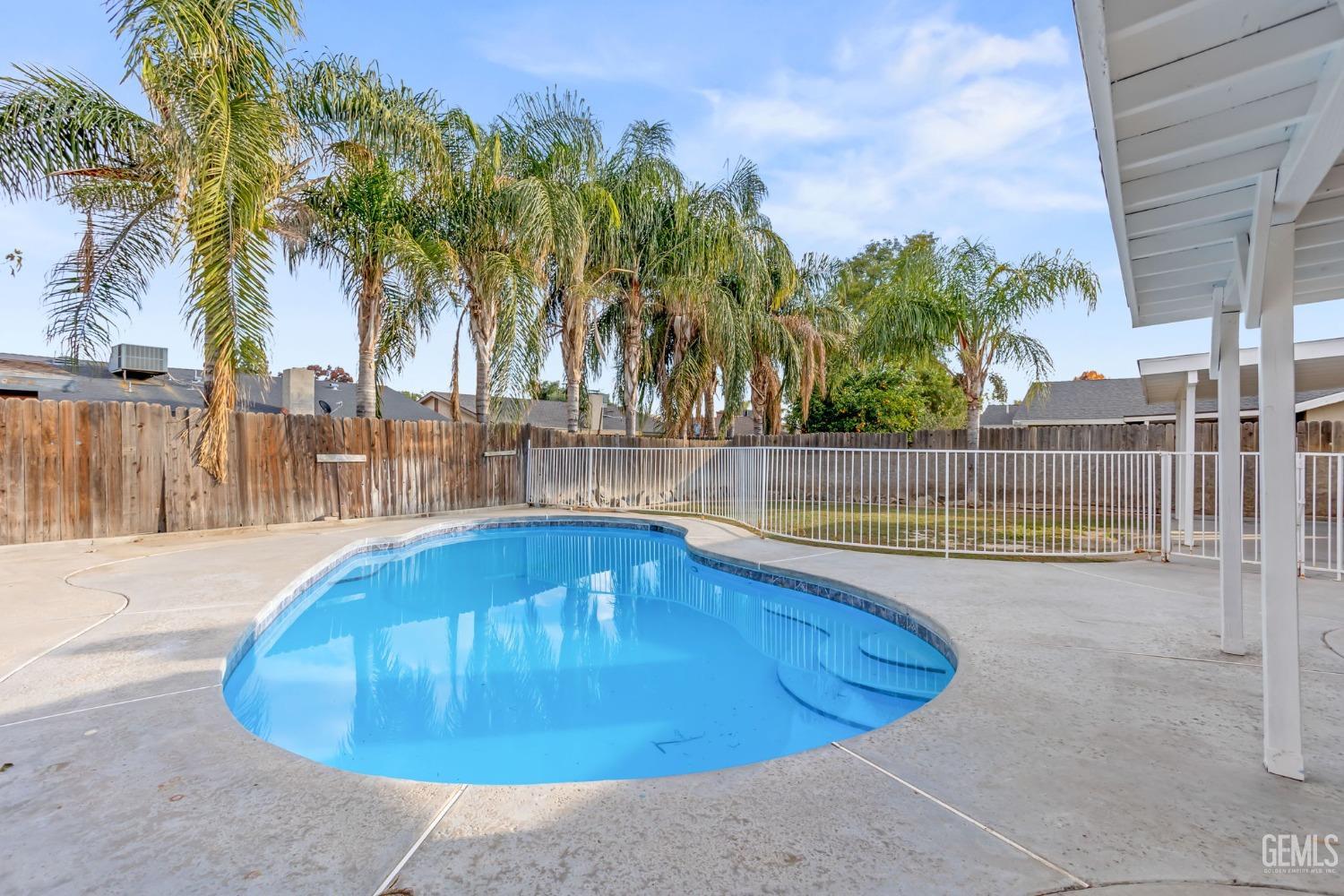 Undisclosed Address Bakersfield, CA 93304 - Photo 29 of 31 a view of a swimming pool with a patio and a yard